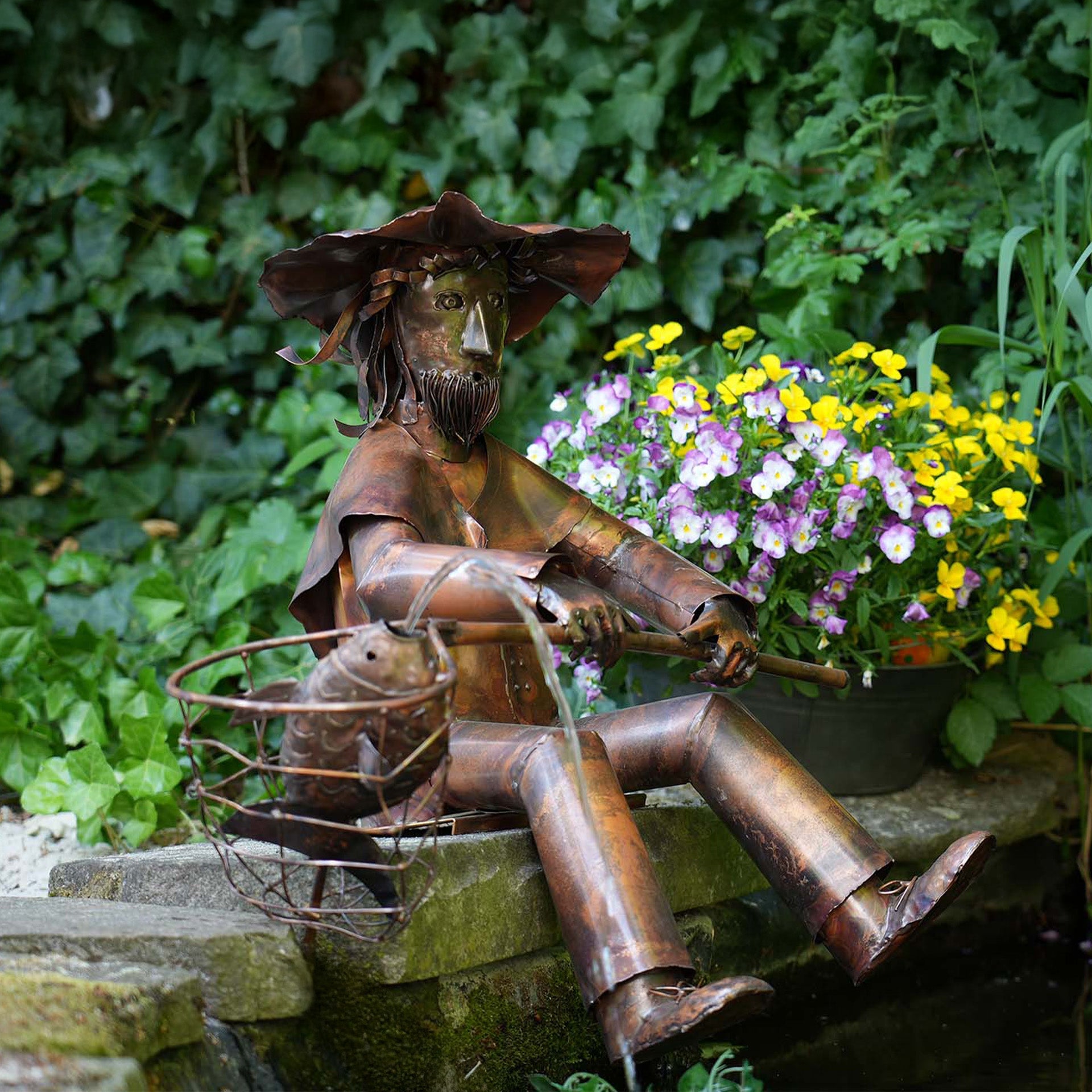 Handgefertigte Kupferfigur in Form eines sitzenden Mannes mit Hut.